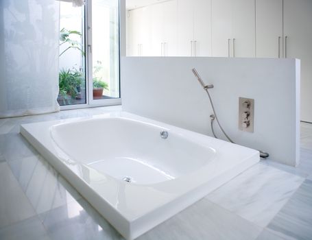 Modern white house bathroom bathtub with marble floor and courtyard skylight