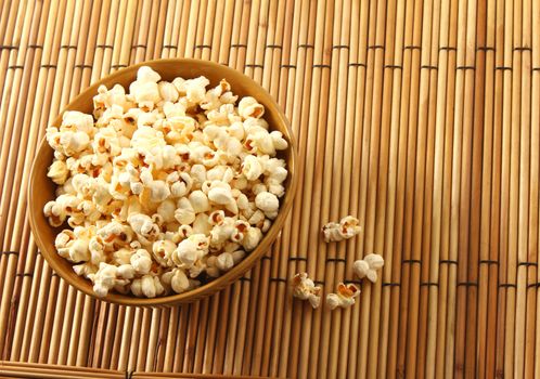 popcorn in bowl putting over mat background