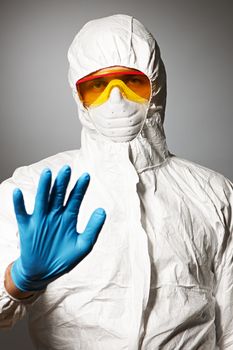 Scientist in protective wear, glasses and respirator 