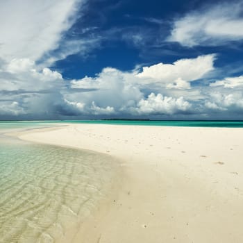 Beautiful island beach with sandspit at Maldives