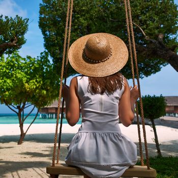 Woman in white dress at tropical beach