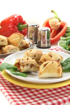 Puff pastry with bell peppers and cheese filling on a light background