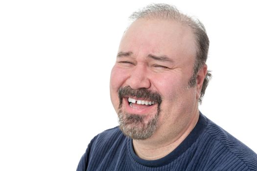 Portrait of a funny mature man laughing hard on a white background