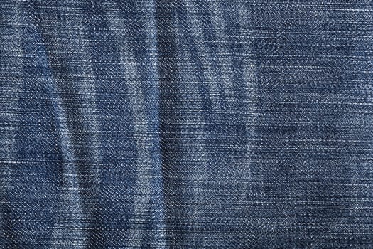 The worn blue jeans, a textile background