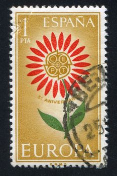 SPAIN - CIRCA 1964: stamp printed by Spain, shows Emblem of Conference of European Post and Telecommunications in a Flower, circa 1964