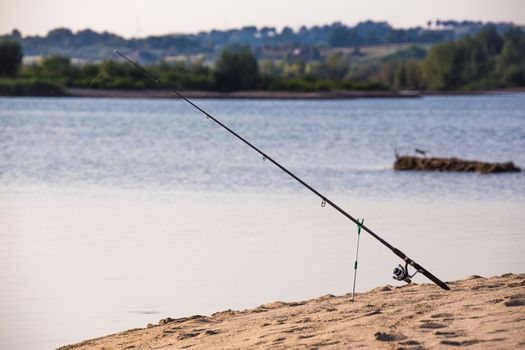 The fishing rod on the sandy beach
