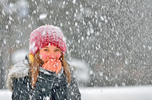 freezing young woman warming his hands