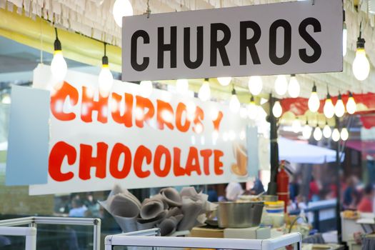 Churros and chocolate fritter typical food in Valencia Fallas fest at spain