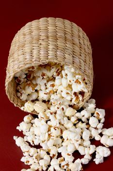 popcorn spreading on red background with bowl