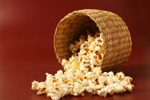 popcorn in bowl with red background