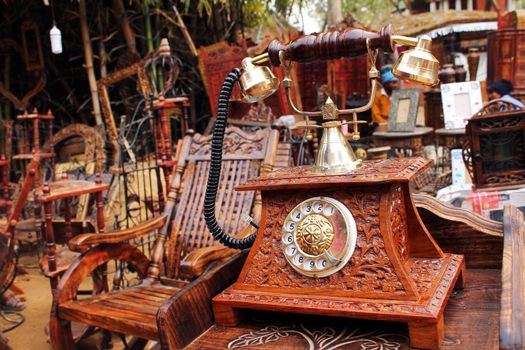 SURJAJKUND FAIR, HARYANA - FEB 12 : antique wooden telephone for sale in shop
