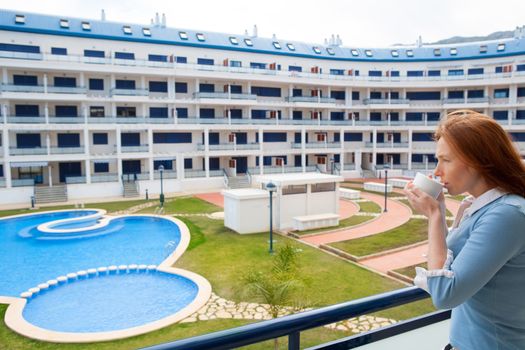 Woman drinking coffee cup in Mediterranean apartment in Spain