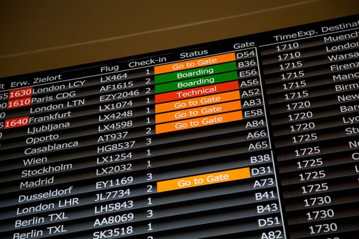 Airport departure board in terminal with flight information