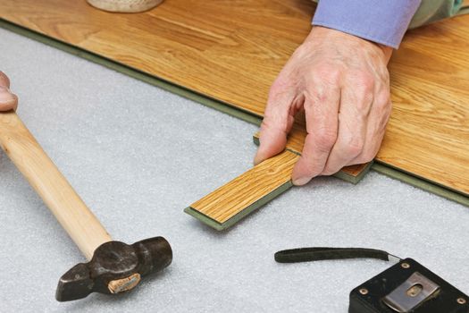 Master works on laying laminate panels, stylized wood