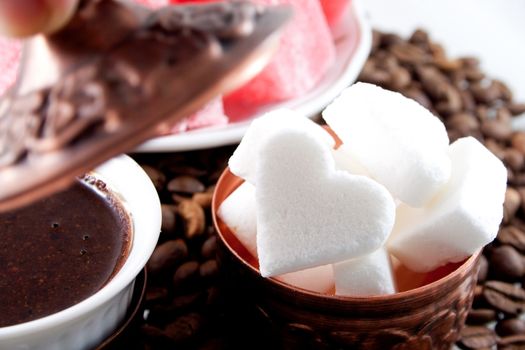 Heart shaped sugar with coffee around