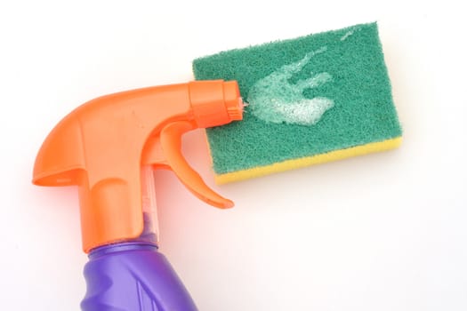 Orange spray bottle with green scourer