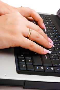 Women's beautiful hand writing on a laptop keyboard