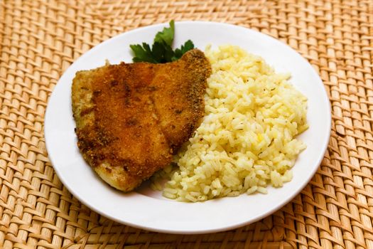 fried breaded tilapia served with rice and herbs