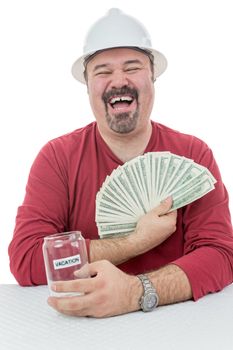 Construction worker laughing with joy holding to vacations money