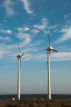 Eletric Power Generator Wind Turbine over a Cloudy Sky