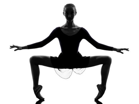 one caucasian young woman ballerina ballet dancer stretching warming up in silhouette studio on white background