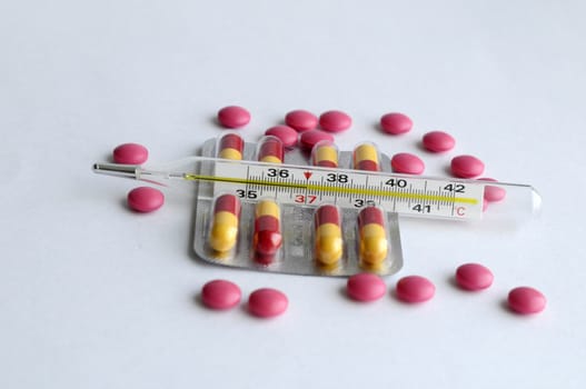 The increased temperature on a thermometer, pills and tablets