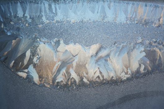 Abstract pattern on a window glass made by frost