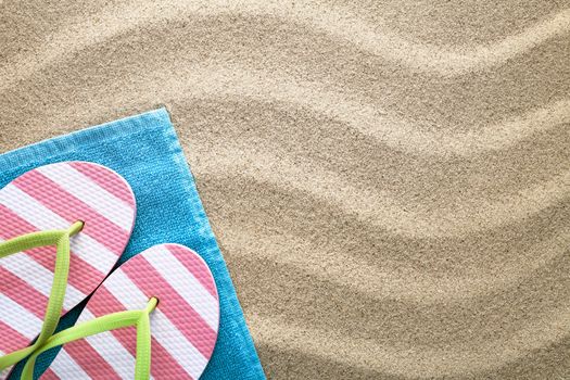 Beach background with towel and flip flops. Summer concept. Top view