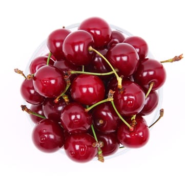 Ripe fresh cherry in the chrystal glass isolated on white background