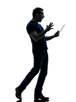 one caucasian man holding digital tablet surprised in silhouette on white background