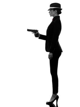 one stylish caucasian woman in suit holding gun in silhouette on white background