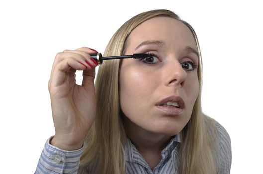 young woman using black mascara on white background