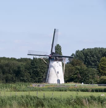 old white windmill in the dutch place Nieuwenhoorn