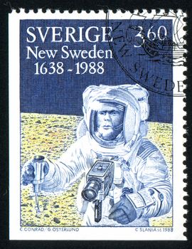 SWEDEN - CIRCA 1988: stamp printed by Sweden, shows American astronaut with Swedish Hasselblad camera on the Moon, circa 1988