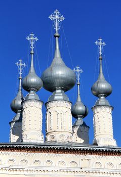 Church cupolas over blue sky