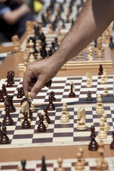 Man playing chess, making the move