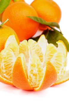 Fresh Ripe Tangerine with Segments and Citrus Peel and Some Full Body with Leafs closeup on white background