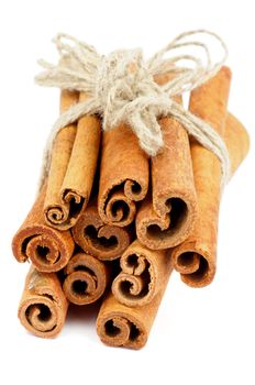 Heap of Cinnamon Sticks with Sewing Threads isolated on white background