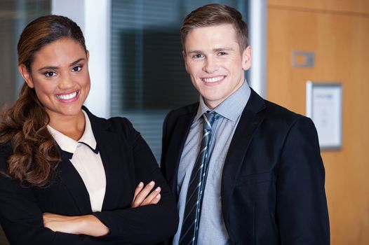 Smiling professionals posing together at office