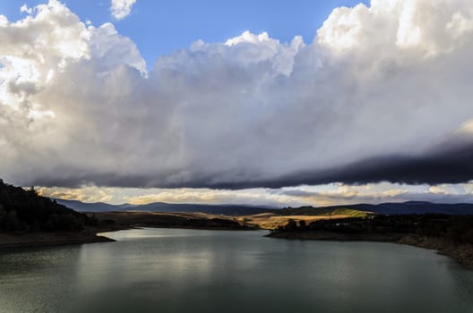Beautiful clouds over the lake in to the mountan of Spain.