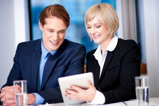 Secretary showing progress report to her boss