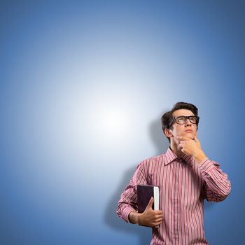 young man scientist in glasses thinking, looking up