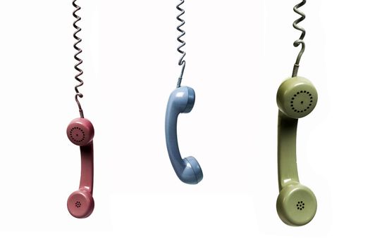 Three phones hanging from several colors isolated on a white background
