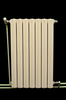 old cast iron radiator isolated on black background
