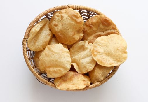 Indian breakfast poori (boori) in a basket with white background