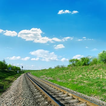 railroad in green landscape and blue sky