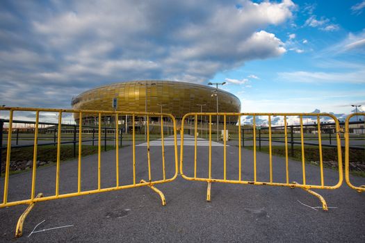 GDANSK, POLAND - SEPTEMBER 19: PGE Yellow gate to the Arena which is a newly built football stadium for Euro 2012 Championship. The stadium has the capacity of the stands for 43,615 spectators. September 19, 2013 in Gdansk, Poland