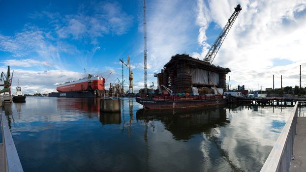 GDANSK, POLAND - SEPTEMBER 19: Docking oil rig at the Gdansk Shipyard under construction with a clear blue sky in the background. The oil rig weights 12 thousand tons. Gdansk, Poland, 2013