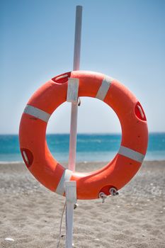 Lifebelt hanging on a stick at the aegean sea. At a very peaceful beach of Crete, Greece, 2013.