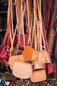 Brown and red Handbags and female shoes  in a local shop at a market in the streets of Crete, Greece , 2013